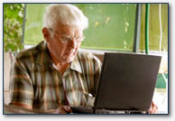 A retirement-age man using a computer