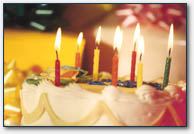 A birthday cake with candles lit