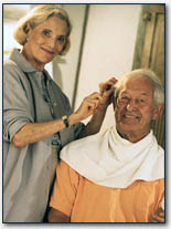 A happy-looking person, age early 60s, working 