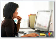 A woman sitting at a desk working with a computer